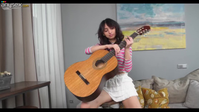 Beautiful Russian brunette is masturbating pussy with her guitar